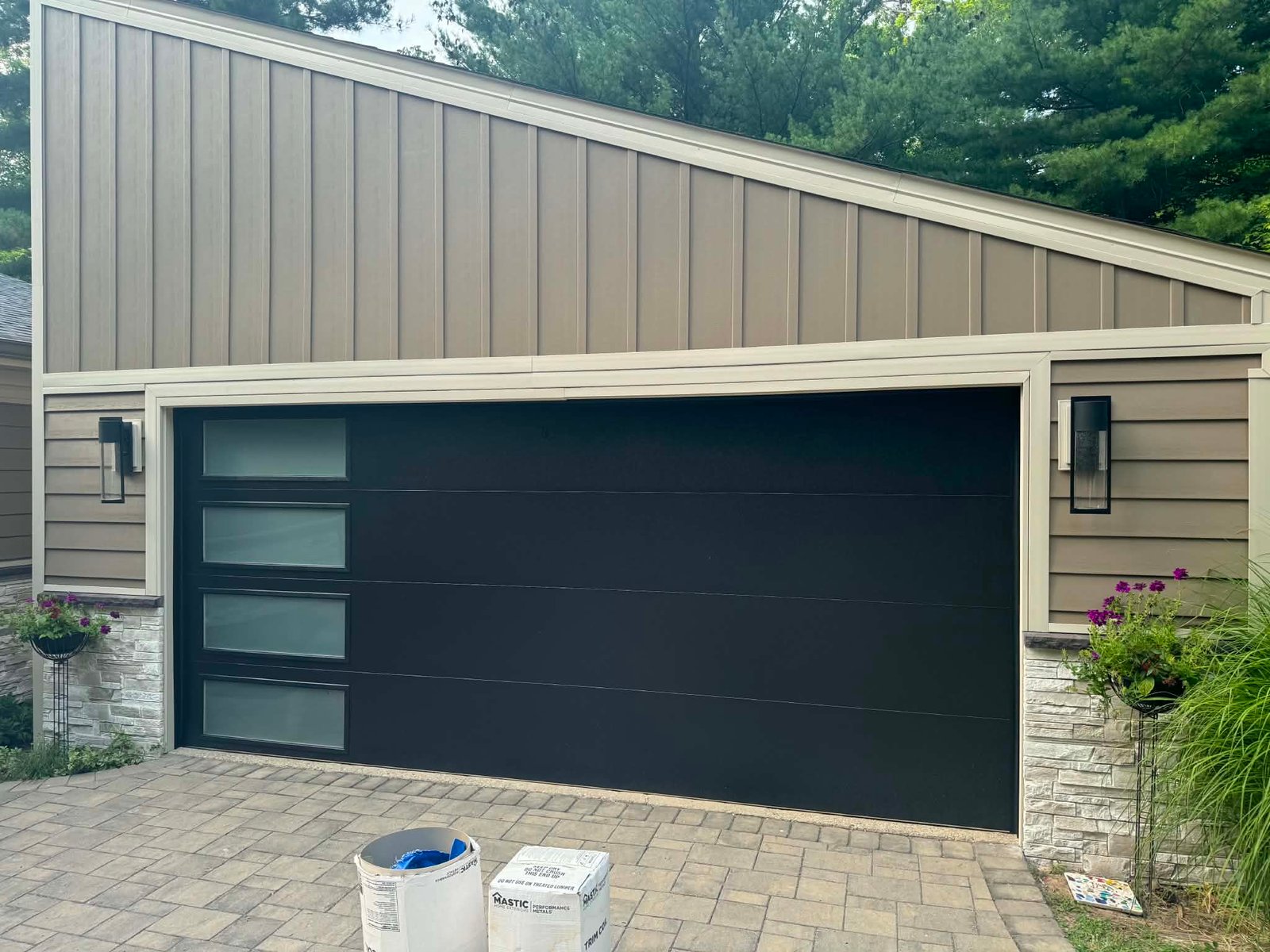 Modern black flush-panel garage door installation