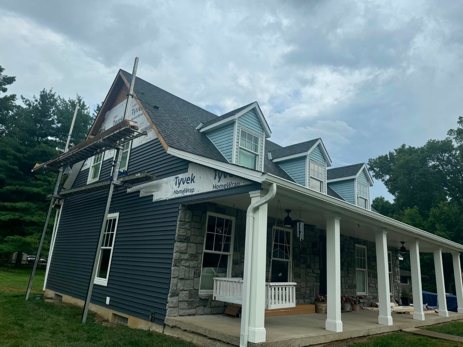 Siding replacement in progress with Tyvek house wrap