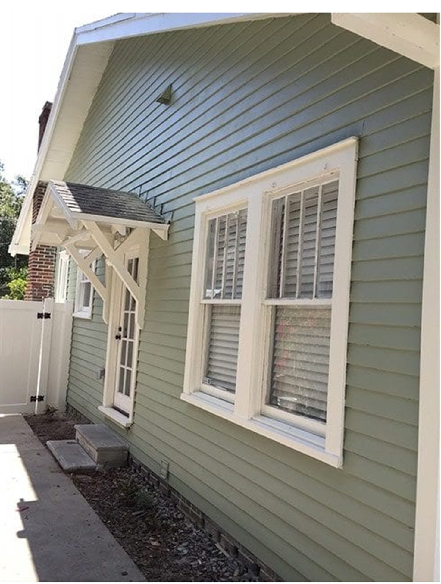 Sage green craftsman-style siding replacement